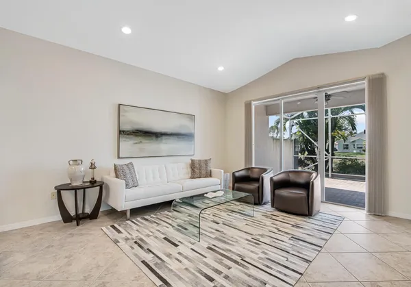 a living room with furniture and a floor to ceiling window