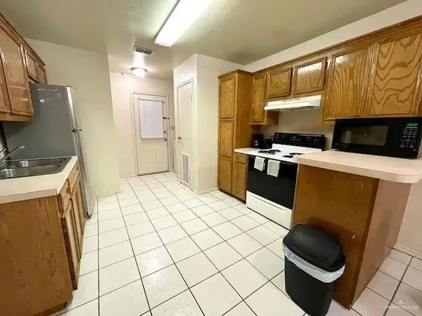 a kitchen with a sink a stove and a refrigerator