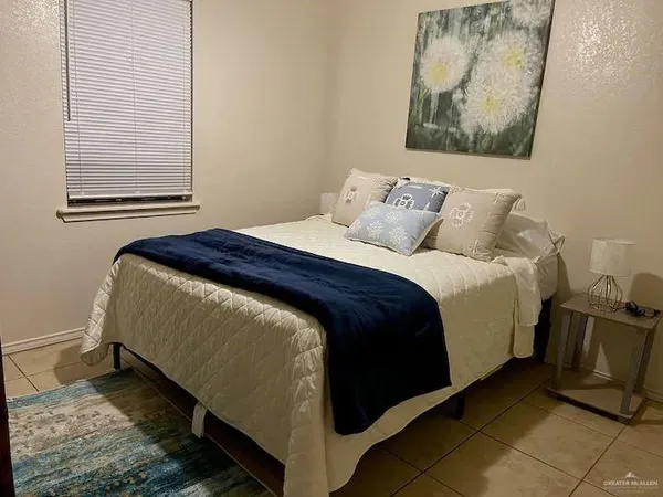 a bed sitting in a bedroom next to a window