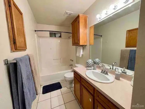 a bathroom with a sink a toilet a mirror a vanity and shower
