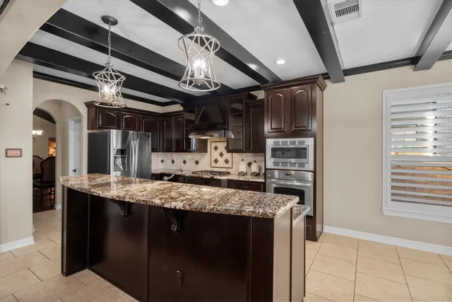 a kitchen with a stove and a refrigerator