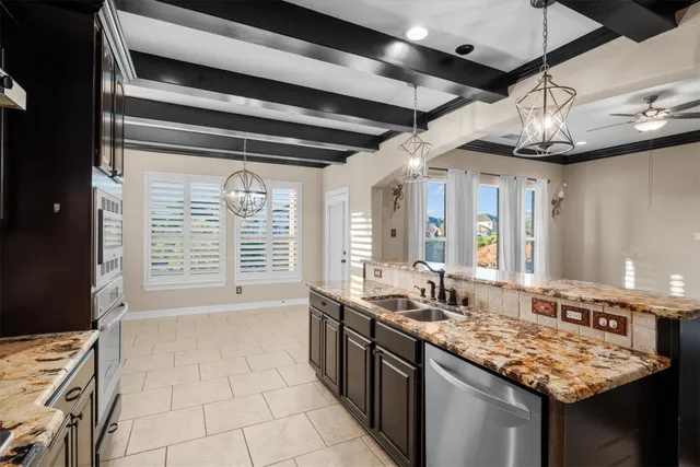 a kitchen with stainless steel appliances granite countertop a sink and stove