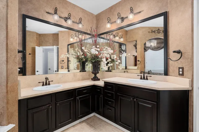 a bathroom with a double vanity sink and a mirror