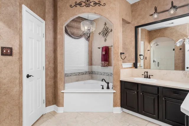 a bathroom with a bathtub sink and mirror