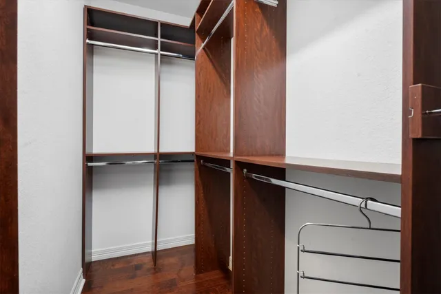 a view of walk in closet with empty racks