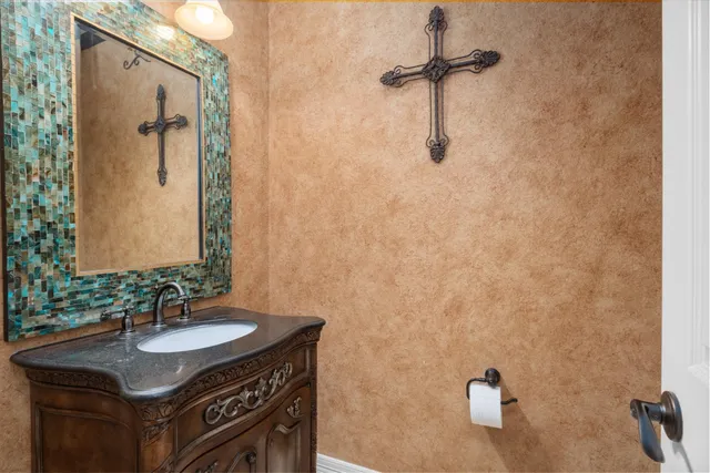 a bathroom with a granite countertop sink a mirror and shower