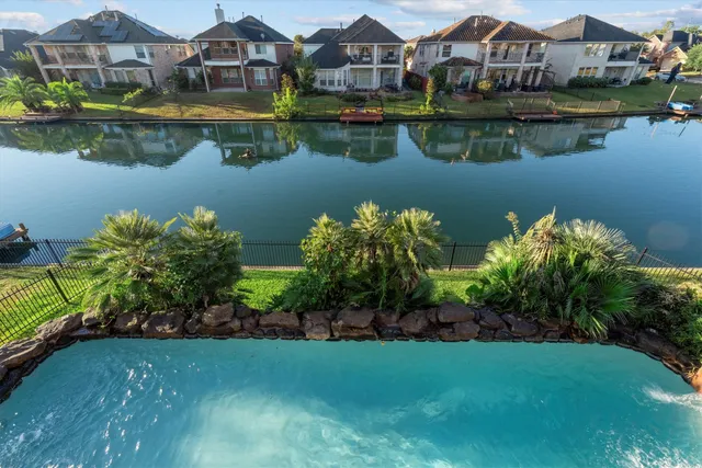 an aerial view of a house with a lake view
