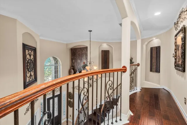 a view of a hallway with furniture and floor to ceiling window