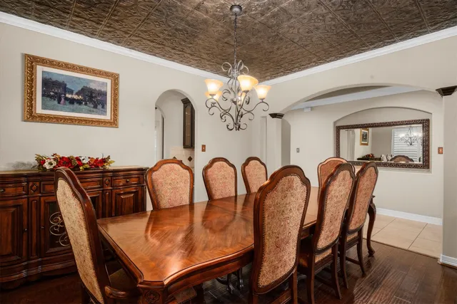 a dining room with furniture and wooden floor