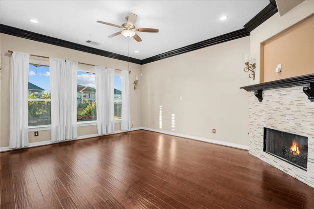 a view of an empty room with a fireplace and a window