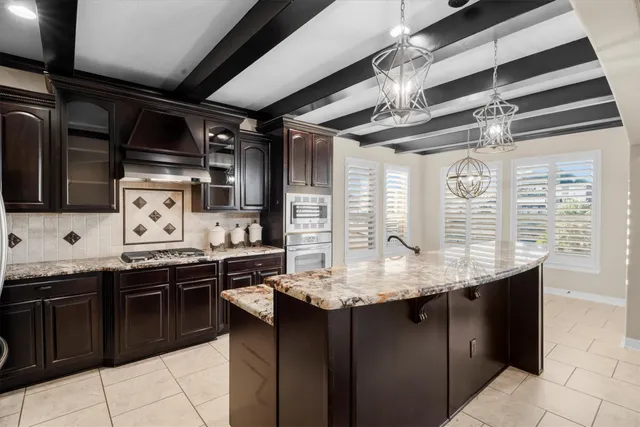 a kitchen with stainless steel appliances granite countertop a sink and cabinets