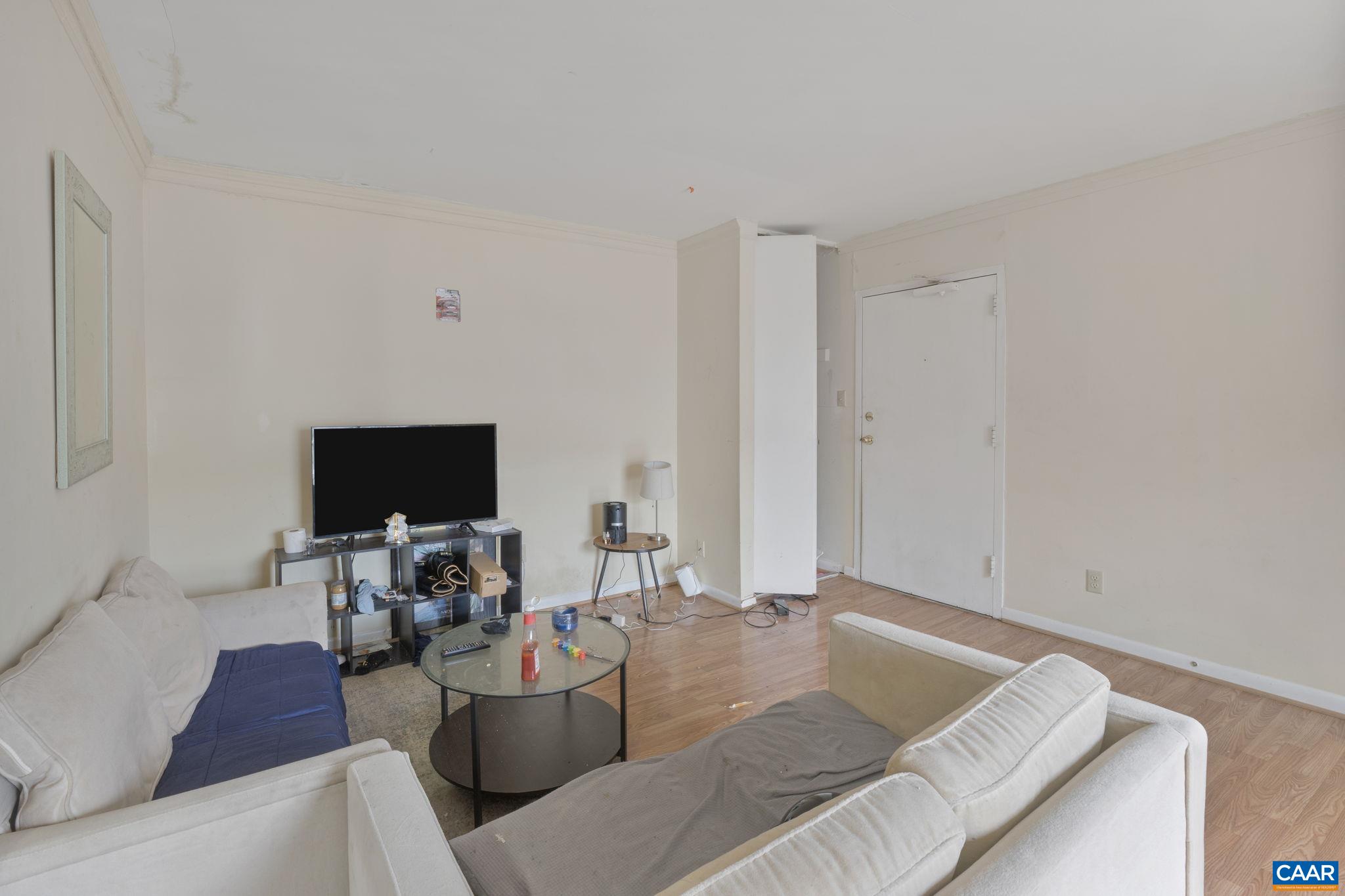 545 Burgoyne Road, Unit 13 Charlottesville, VA 22901 - Photo 5 of 7 a living room with furniture and a flat screen tv