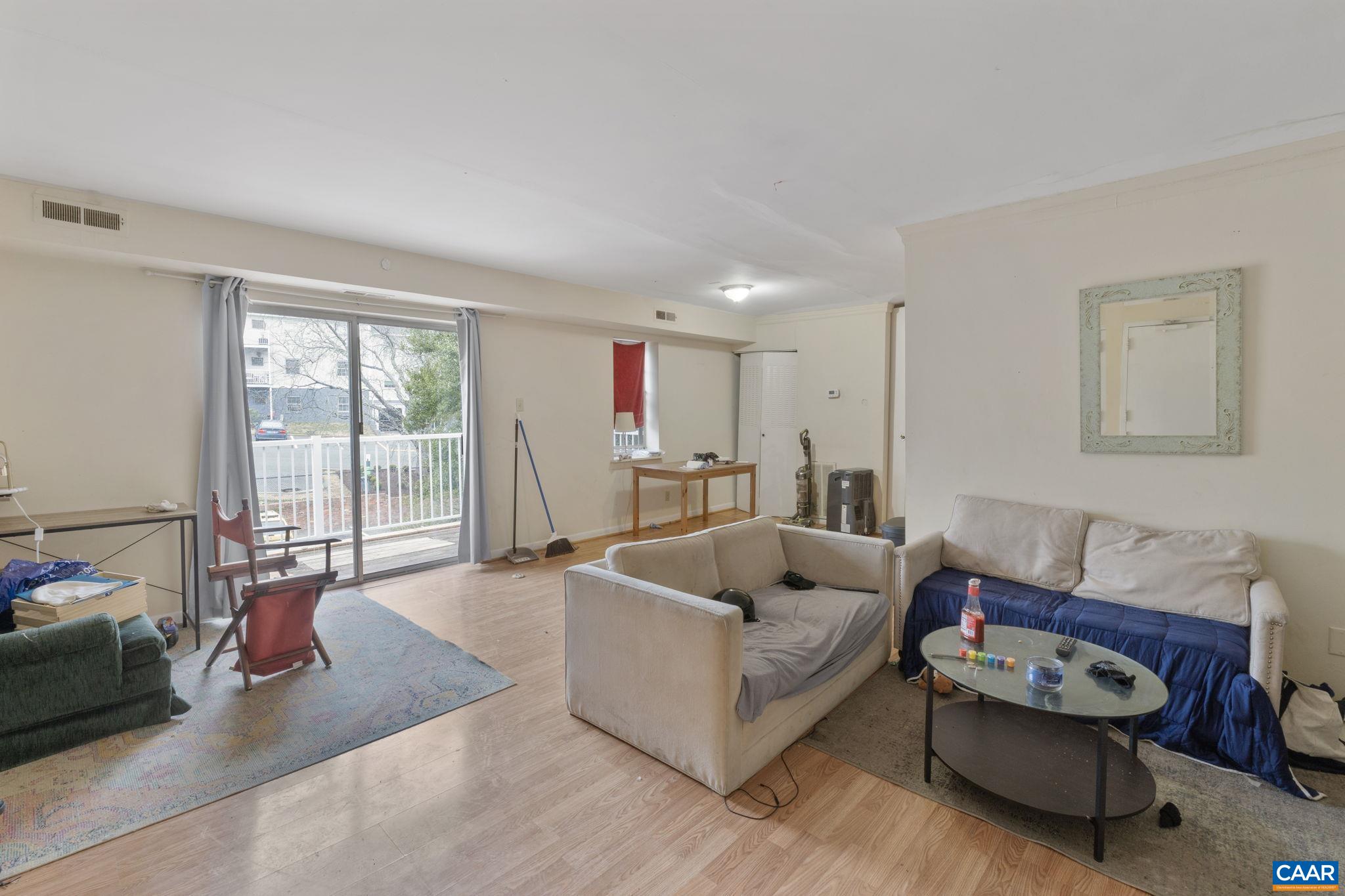 545 Burgoyne Road, Unit 13 Charlottesville, VA 22901 - Photo 6 of 7 a living room with furniture and a large window