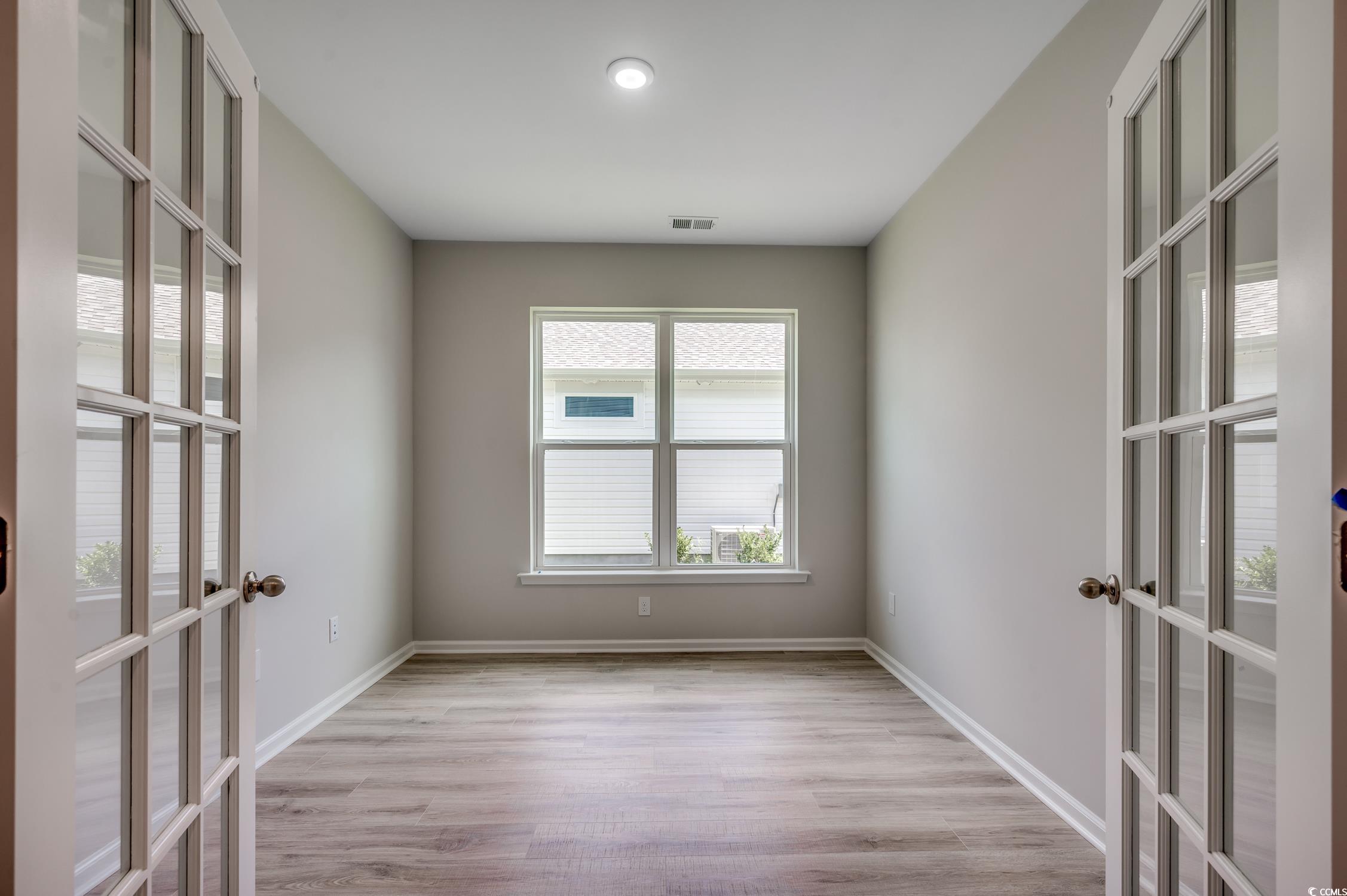 439 Kapalua Loop Little River, SC 29566 - Photo 18 of 36 Empty room with french doors and light wood-style flooring