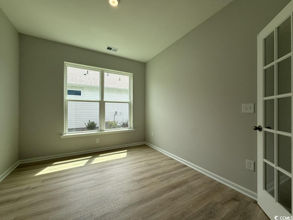 439 Kapalua Loop Little River, SC 29566 - Photo 19 of 36 Empty room featuring baseboards and wood finished floors