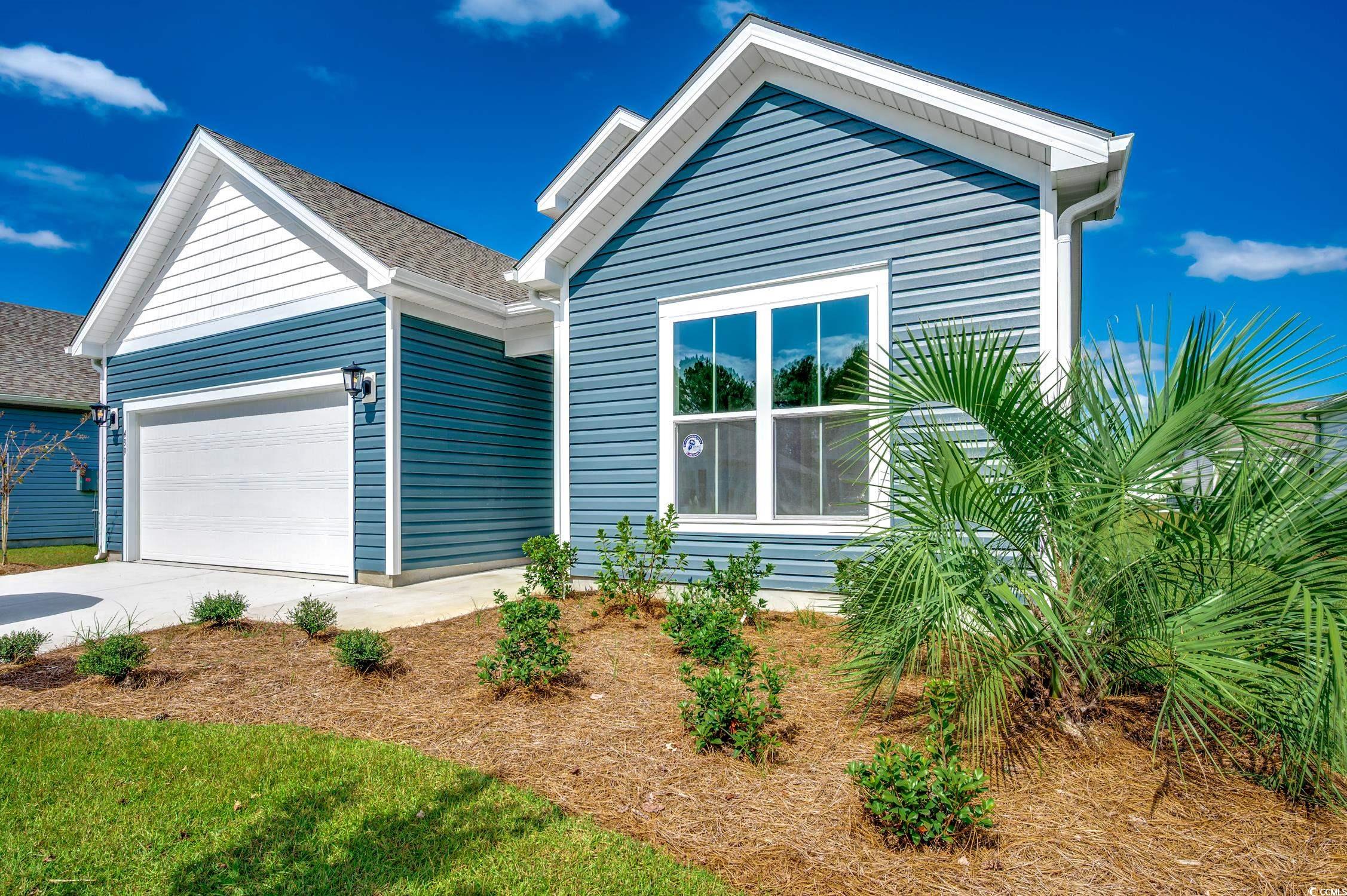 439 Kapalua Loop Little River, SC 29566 - Photo 2 of 36 View of front of property featuring driveway, an attached garage, and roof with shingles