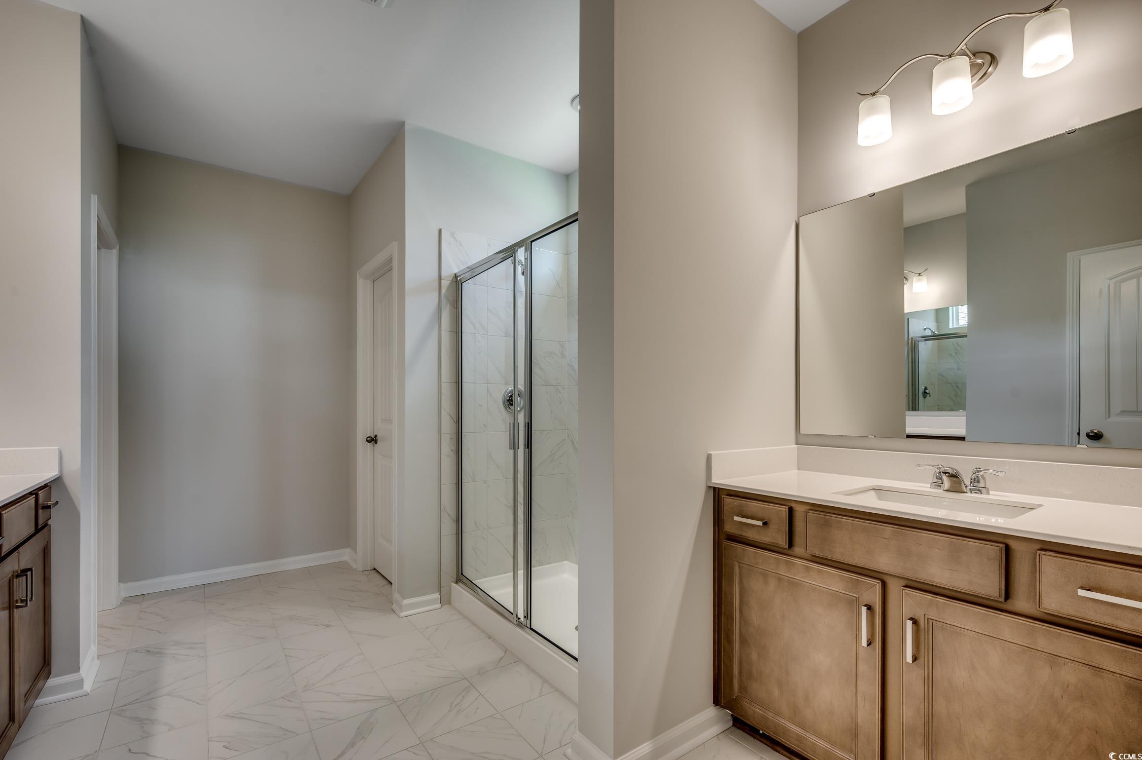 439 Kapalua Loop Little River, SC 29566 - Photo 23 of 36 Full bath featuring vanity, a marble finish shower, and light marble finish flooring