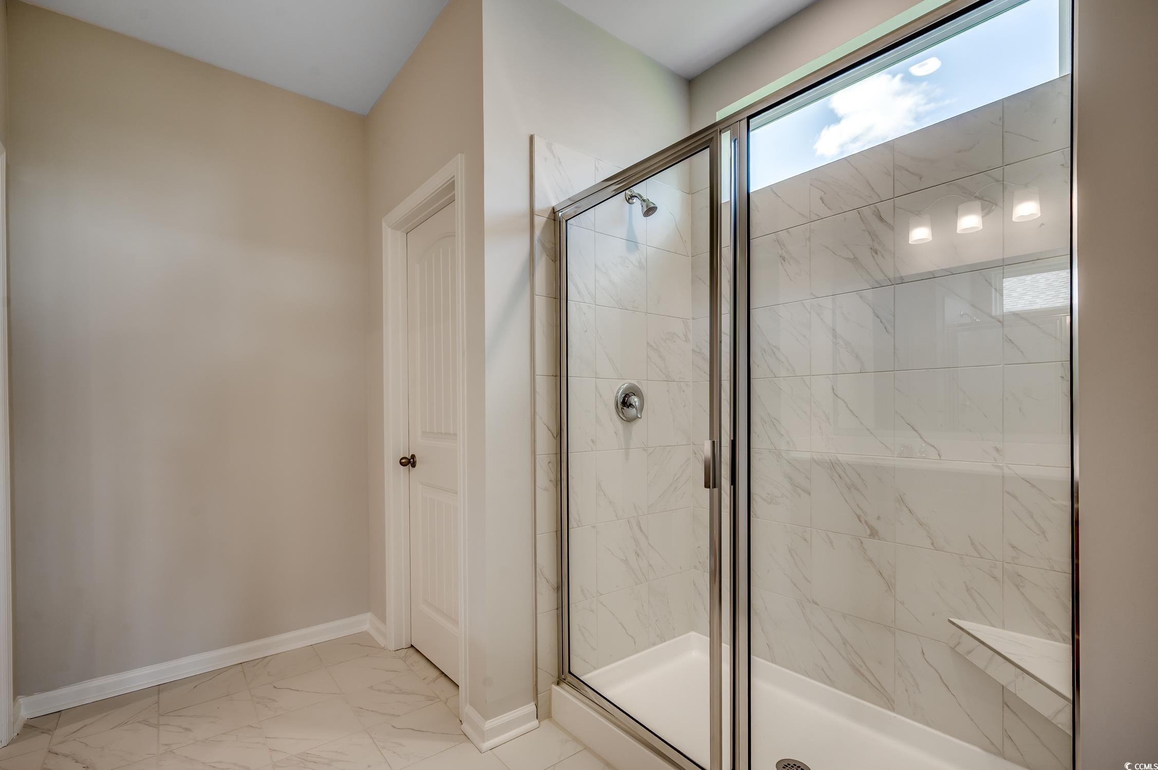 439 Kapalua Loop Little River, SC 29566 - Photo 25 of 36 Full bathroom with light marble finish flooring and a marble finish shower