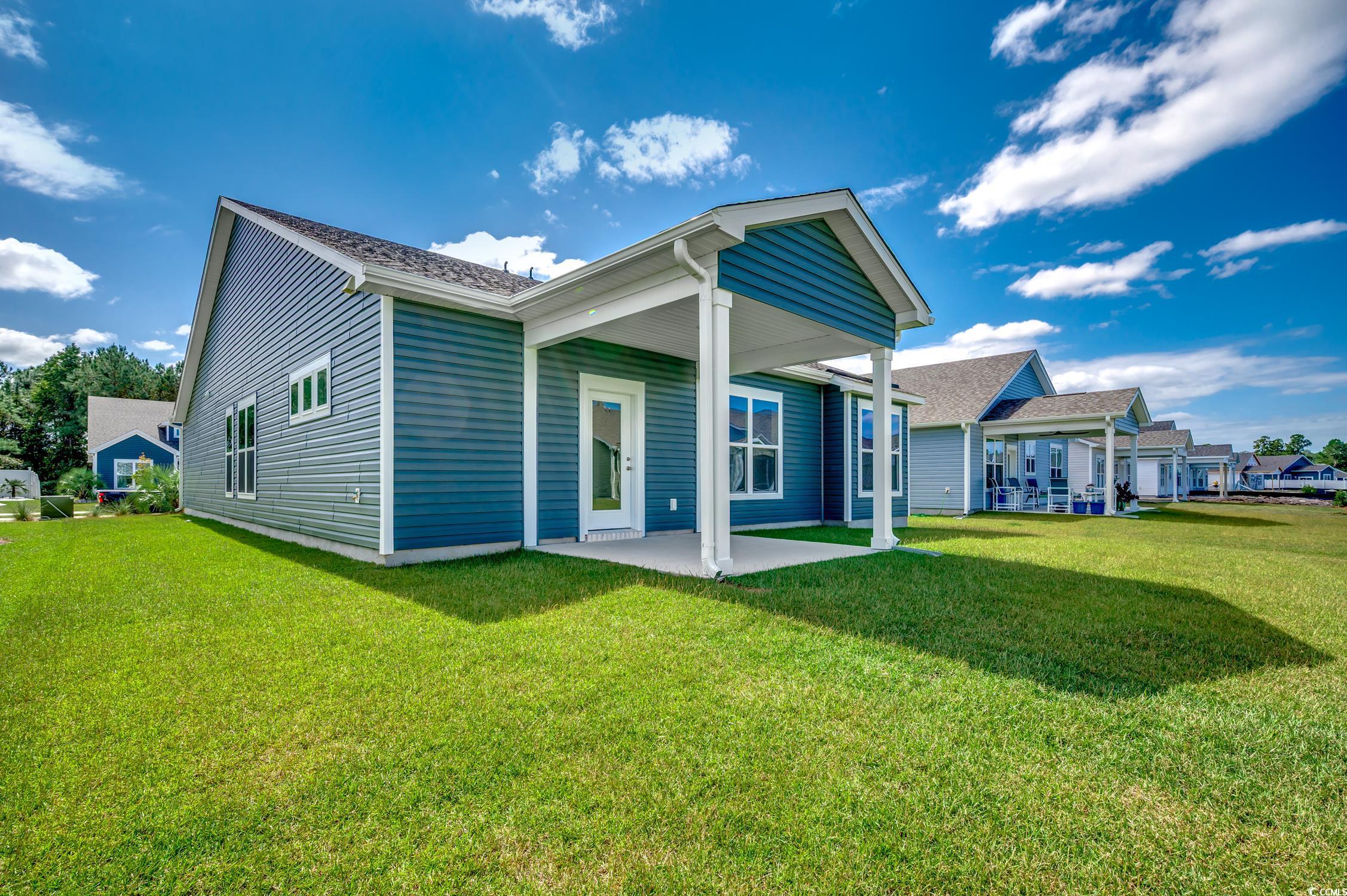 439 Kapalua Loop Little River, SC 29566 - Photo 33 of 36 Back of house with a patio area and a yard