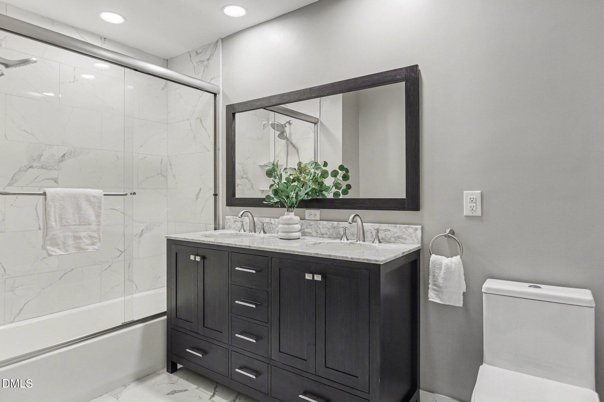 2600 Wade Avenue Raleigh, NC 27607 - Photo 19 of 31 a bathroom with a double vanity sink mirror and toilet