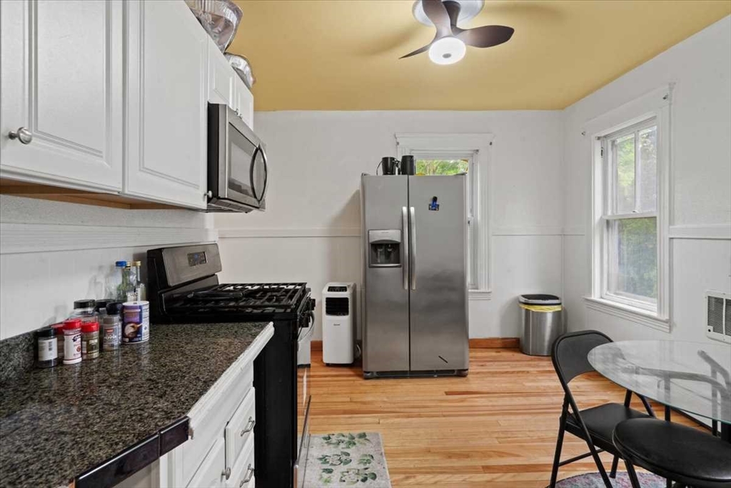 3 Wallace Street Worcester, MA 01605 - Photo 12 of 29 a kitchen with stainless steel appliances granite countertop a refrigerator a stove and a sink with dishwasher