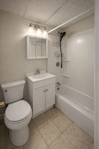 a bathroom with a toilet sink vanity and bathtub