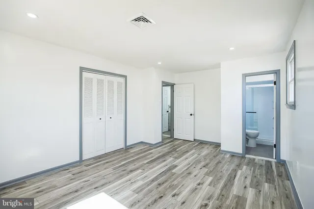 a view of a room with wooden floor and bathroom view