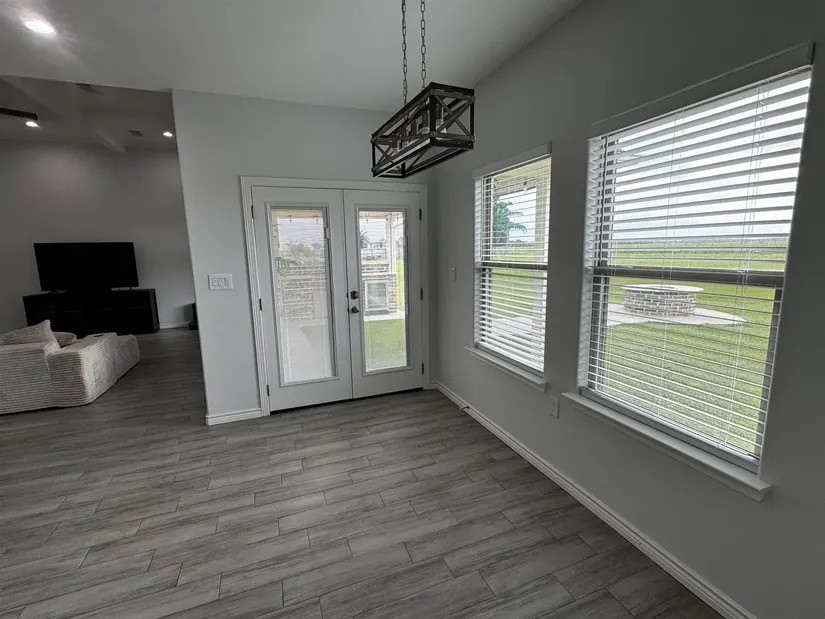 2295 Diamond D Lane Beaumont, TX 77713 - Photo 9 of 40 a view of an empty room with wooden floor and a window