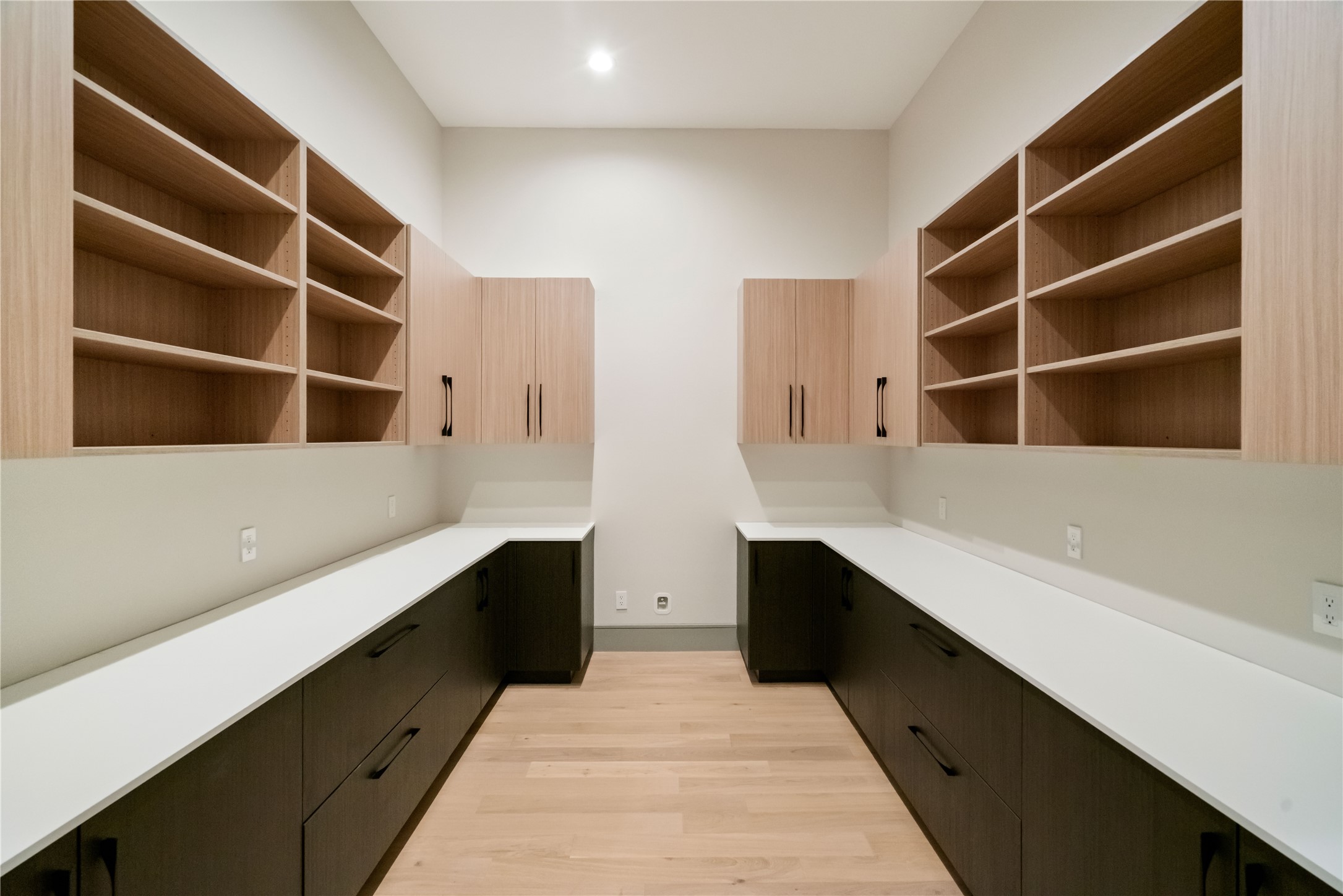 47 Pronghorn Place Spring, TX 77389 - Photo 13 of 44 This spacious utility room features ample wooden cabinetry for storage, sleek countertops, and an efficient layout perfect for organizing household essentials.