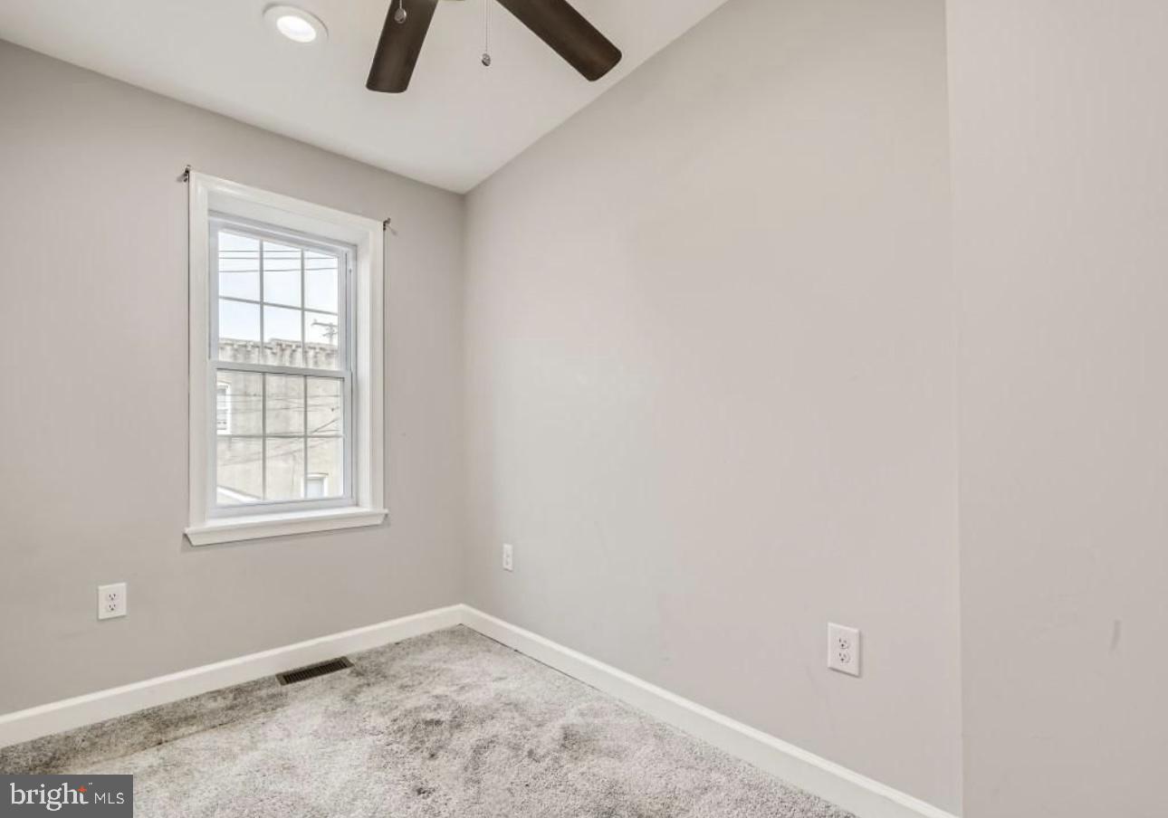 905 East Patapsco Avenue Baltimore, MD 21225 - Photo 12 of 25 an empty room with windows and fan