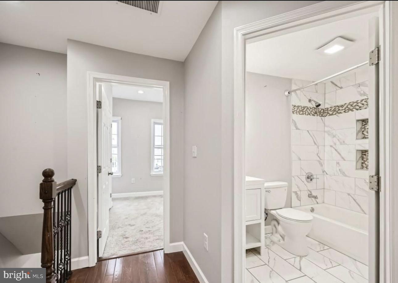 905 East Patapsco Avenue Baltimore, MD 21225 - Photo 14 of 25 a bathroom with a toilet a sink and shower