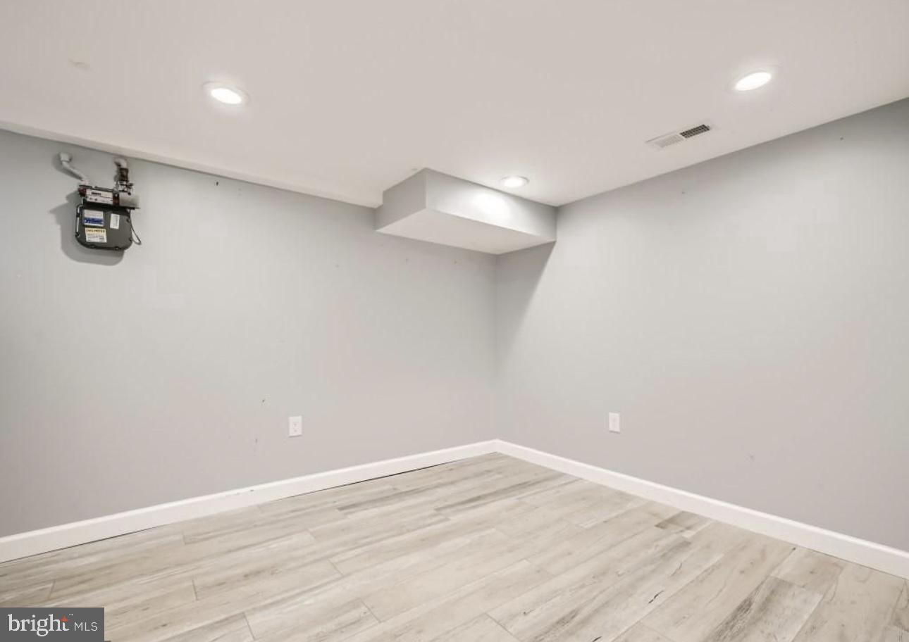 905 East Patapsco Avenue Baltimore, MD 21225 - Photo 17 of 25 a view of a room with wooden floor and white walls