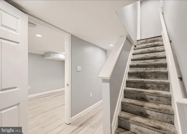 a view of entryway with wooden floor and stairs