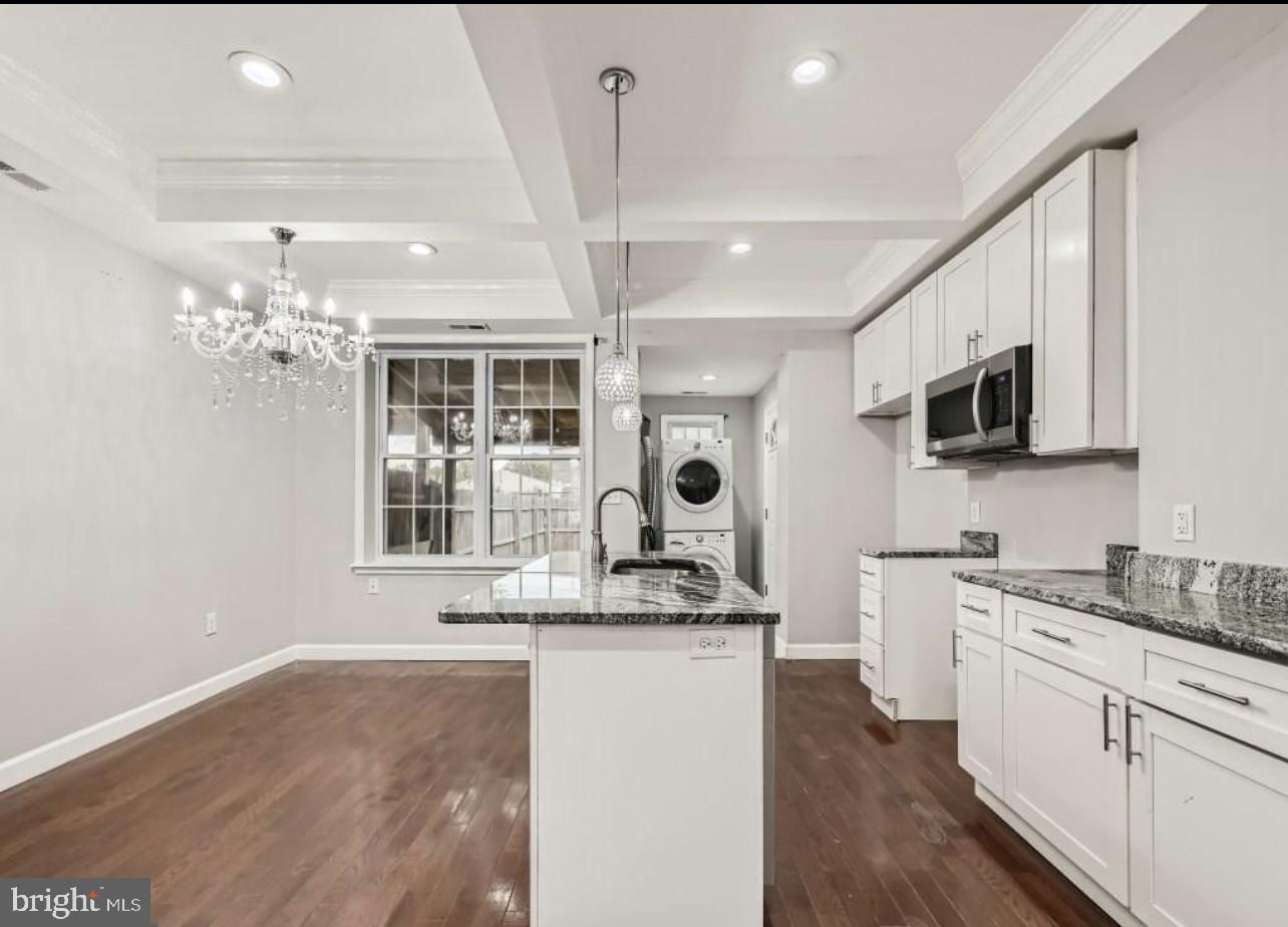 905 East Patapsco Avenue Baltimore, MD 21225 - Photo 6 of 25 a kitchen with granite countertop a sink stainless steel appliances and cabinets