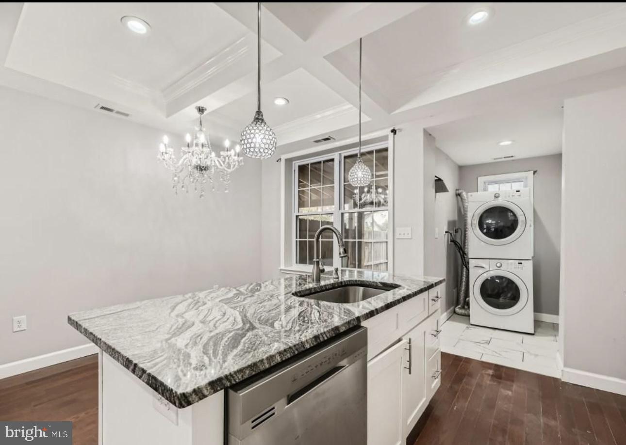 905 East Patapsco Avenue Baltimore, MD 21225 - Photo 7 of 25 a kitchen with stainless steel appliances granite countertop a sink and a stove