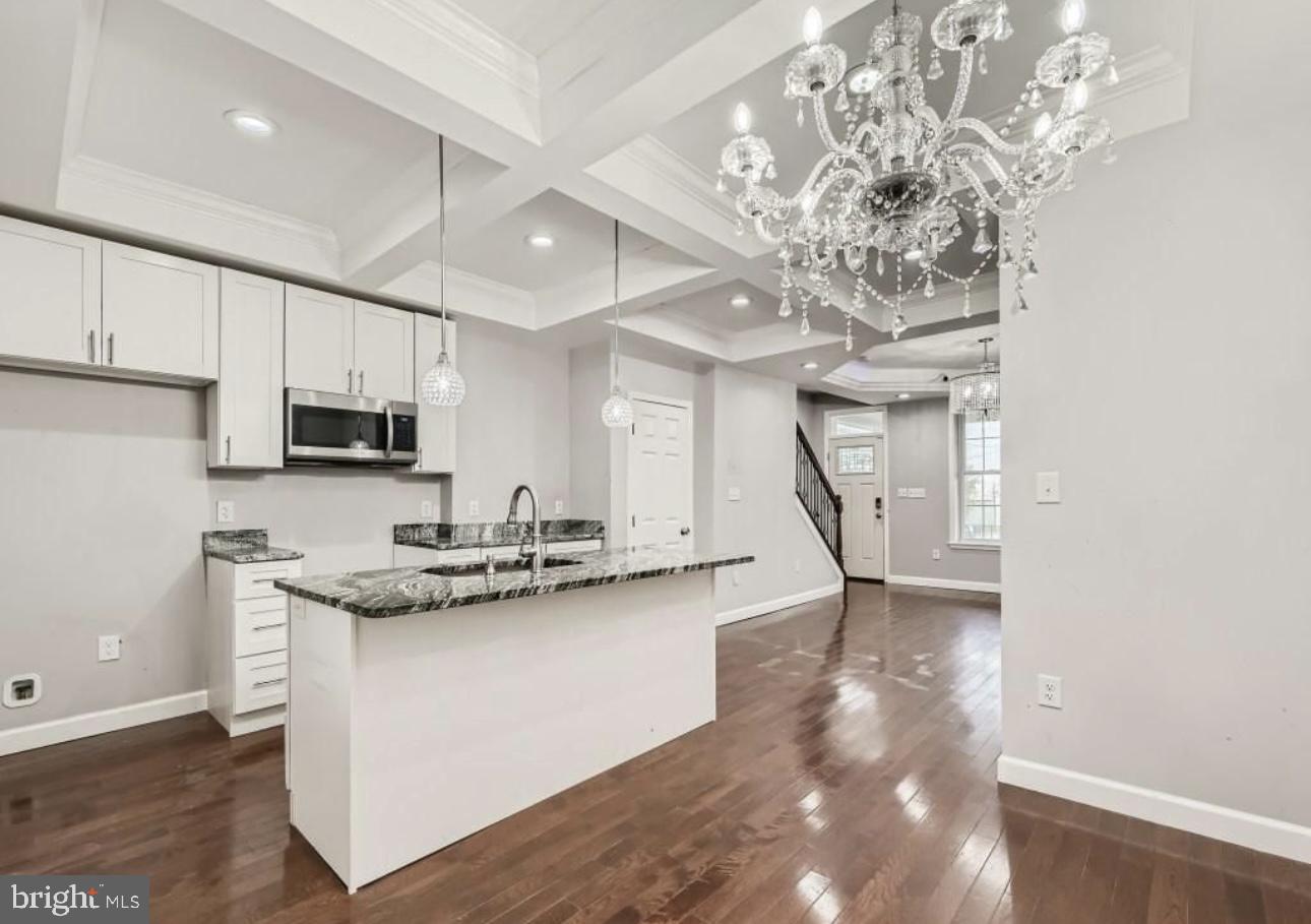905 East Patapsco Avenue Baltimore, MD 21225 - Photo 9 of 25 a kitchen with stainless steel appliances granite countertop a sink a stove and a refrigerator