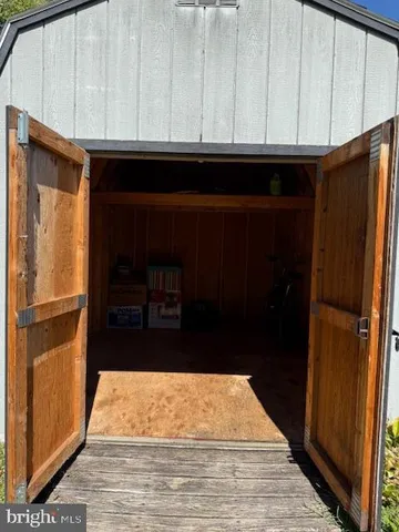 a room with granite countertop white cabinets and refrigerator