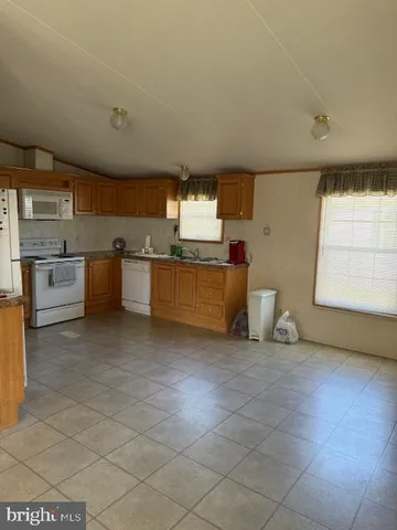 a large kitchen with a stove a sink dishwasher and a refrigerator