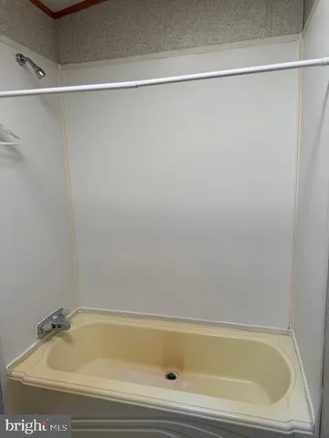 a bathroom with a shower and a sink