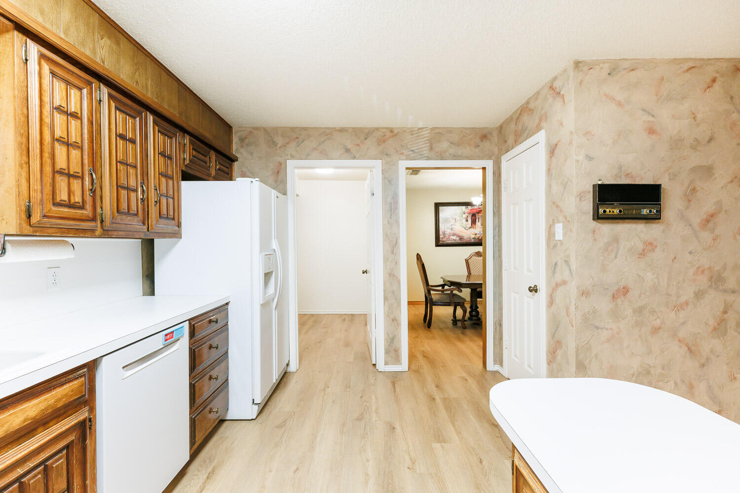 5717 72nd Street Lubbock, TX 79424 - Photo 13 of 54 a kitchen with stainless steel appliances a refrigerator and a stove top oven