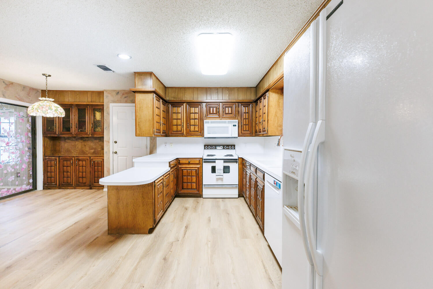 5717 72nd Street Lubbock, TX 79424 - Photo 14 of 54 a large white kitchen with a large window
