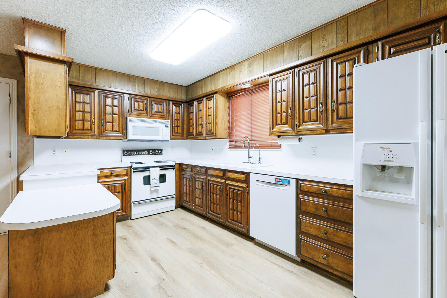 5717 72nd Street Lubbock, TX 79424 - Photo 17 of 54 a kitchen with stainless steel appliances granite countertop a sink stove cabinets and wooden floor