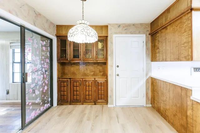 a bathroom with a glass shower door and a glass door