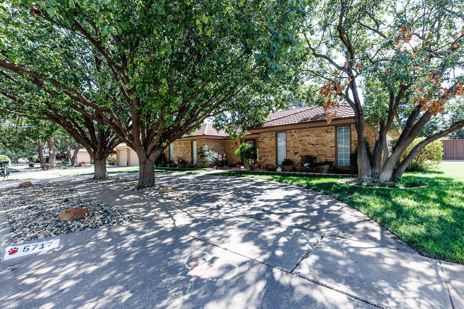 5717 72nd Street Lubbock, TX 79424 - Photo 2 of 54 a front view of a house with garden