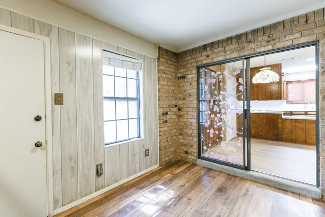 a view of an empty room with glass door