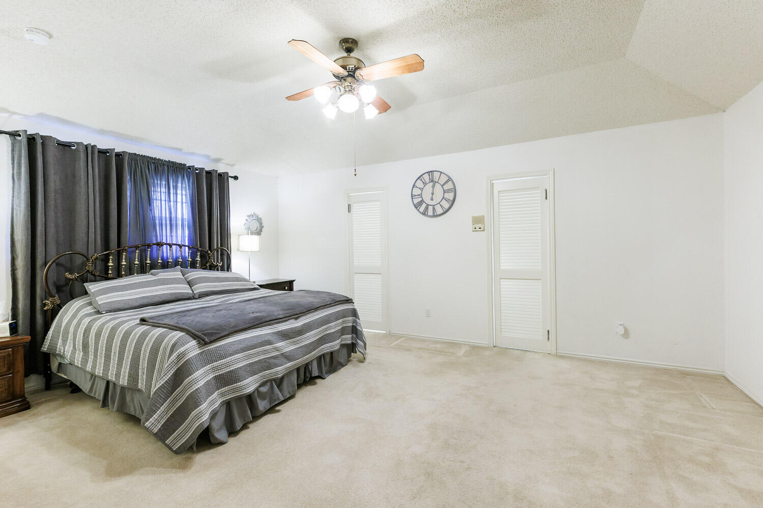 5717 72nd Street Lubbock, TX 79424 - Photo 23 of 54 a bedroom with a bed and a chandelier