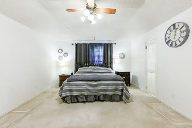 a view of a bedroom with a sink and a chandelier fan