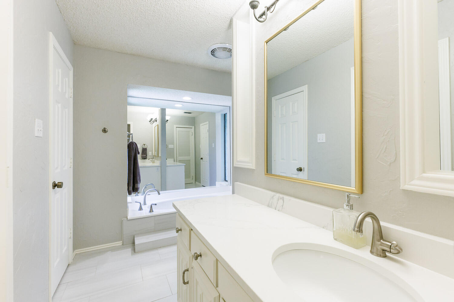 5717 72nd Street Lubbock, TX 79424 - Photo 26 of 54 a bathroom with a sink and a mirror
