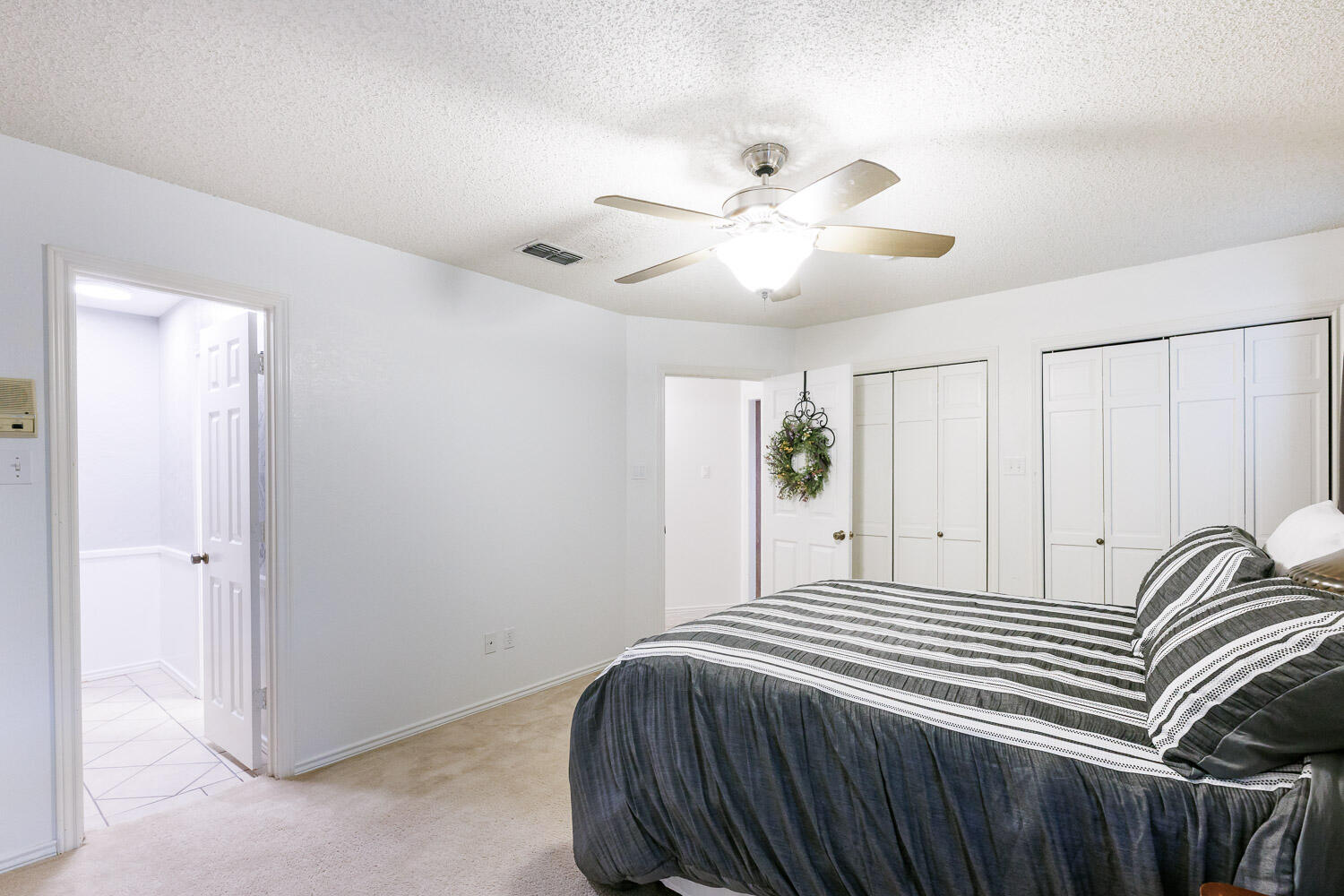 5717 72nd Street Lubbock, TX 79424 - Photo 33 of 54 a bedroom with a bed and a chandelier
