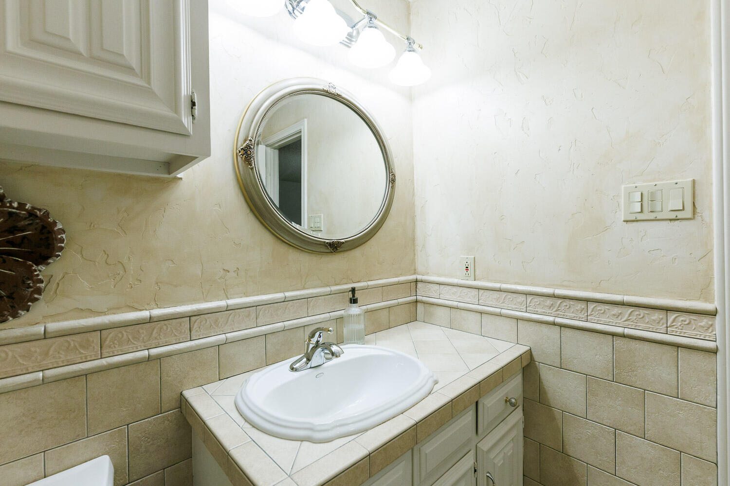 5717 72nd Street Lubbock, TX 79424 - Photo 35 of 54 a bathroom with a sink and a mirror